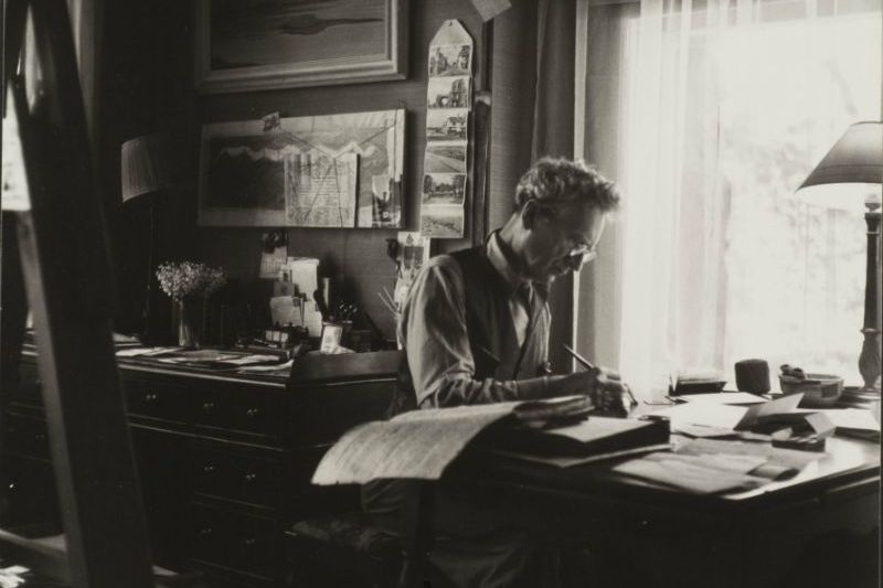 Percy Grainger at his desk, in black and white