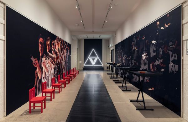 install view of a museum showing a fluorescent light sculpture at end of hallway